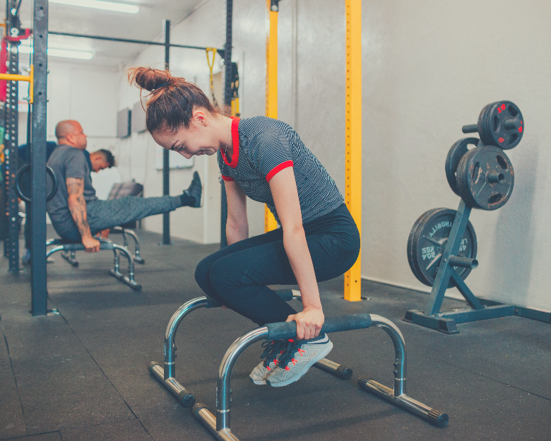 women doing dips with power tower