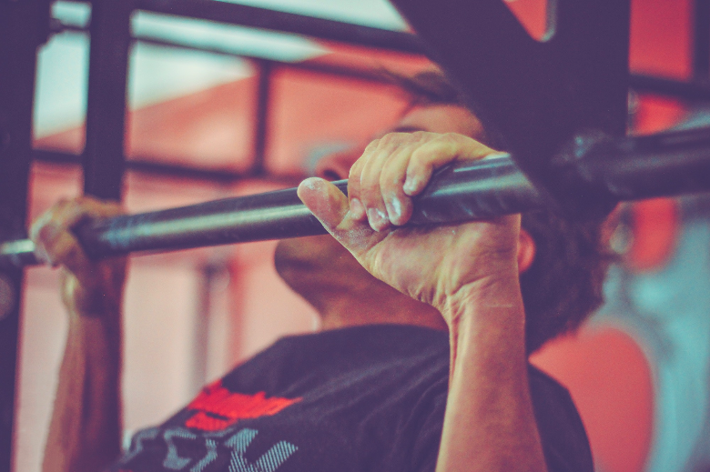 man doing pull up with a mall mounted pull up bar