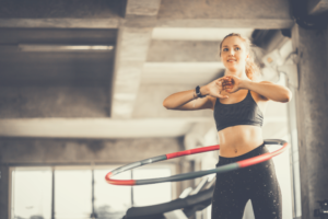 Using a weighted hula hoop is a great way to have fun while doing whole body exercise